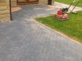 Kiln dried sand brushed into joints of block paving to strengthen bonding, then compressed