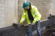 Office wall in Sheffield being built by a bricklayer in 2009