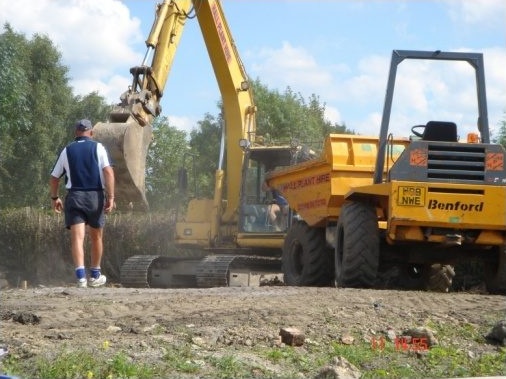 Digger digging out trench in preparation for foundations