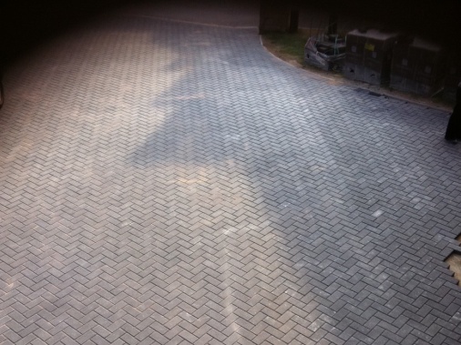 200msq area of charcoal block paving laid to form a camber to the driveway (camber meaning a graduated curvature)